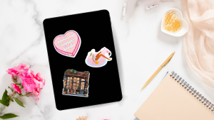 A flatlay of an e-reader with three stickers on it